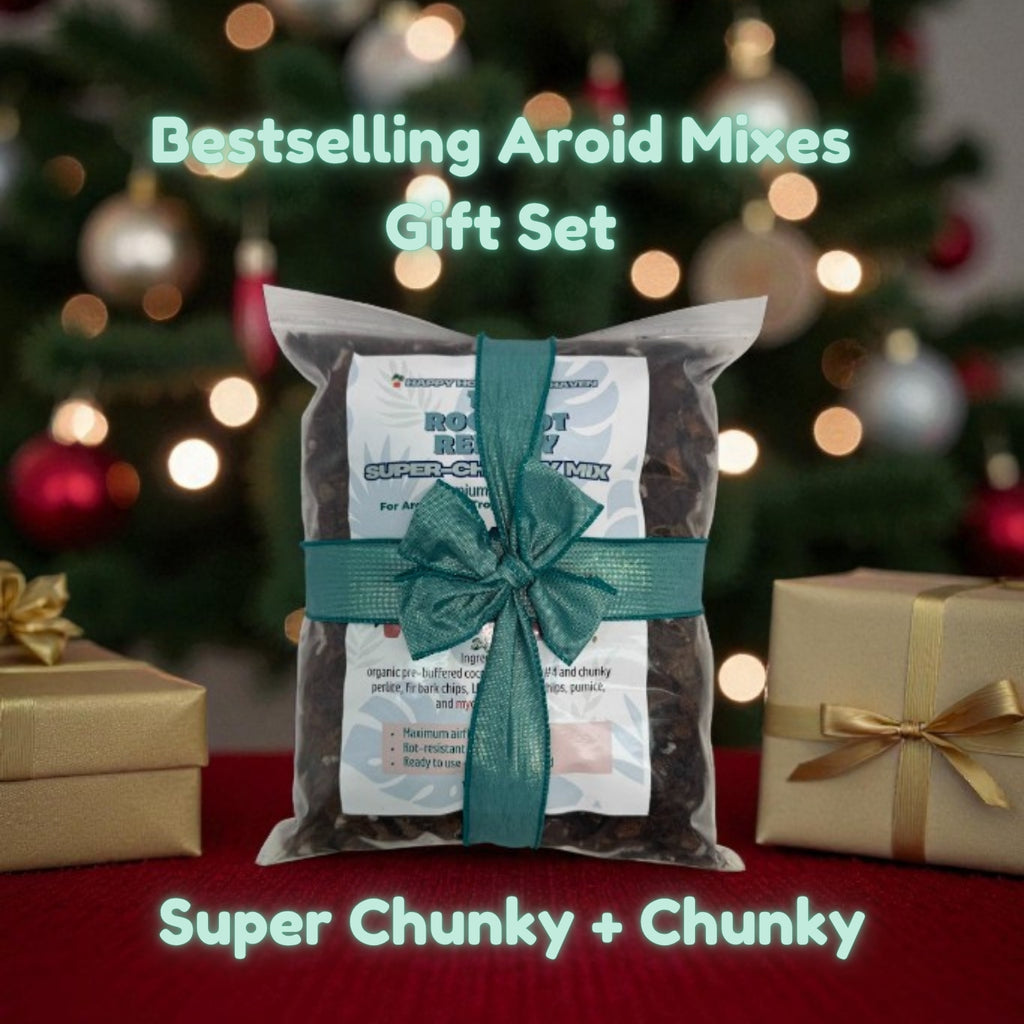 Gift set with Aroid Mixes in front of a Christmas tree with presents.