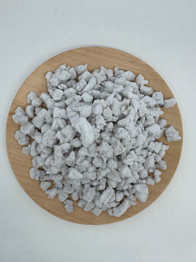 Perlite on a wooden board with a white background