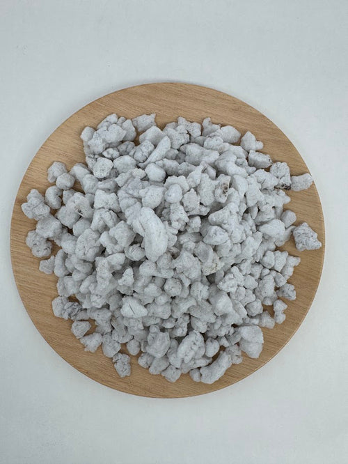 Perlite on a wooden board with a white background