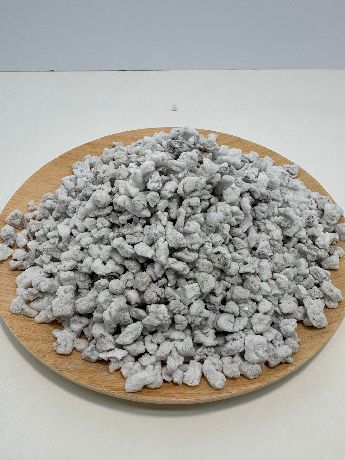 #3 perlite on a wooden plate with a white background