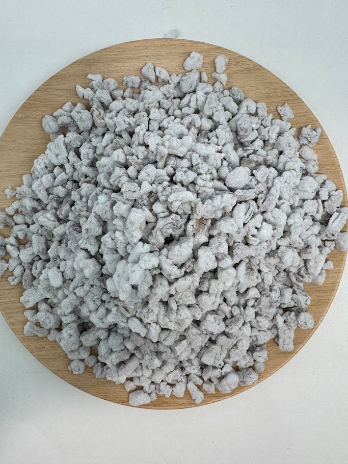 #3 size perlite on a wooden board with a white background