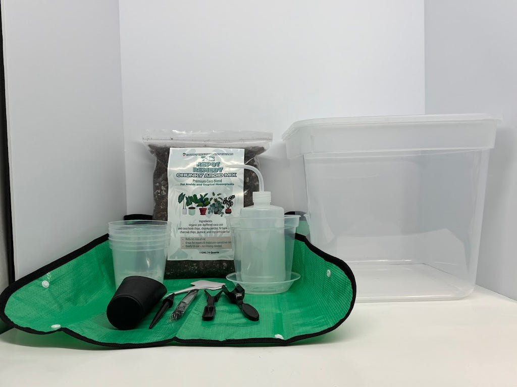 Set of gardening tools and supplies on a green mat with a white background