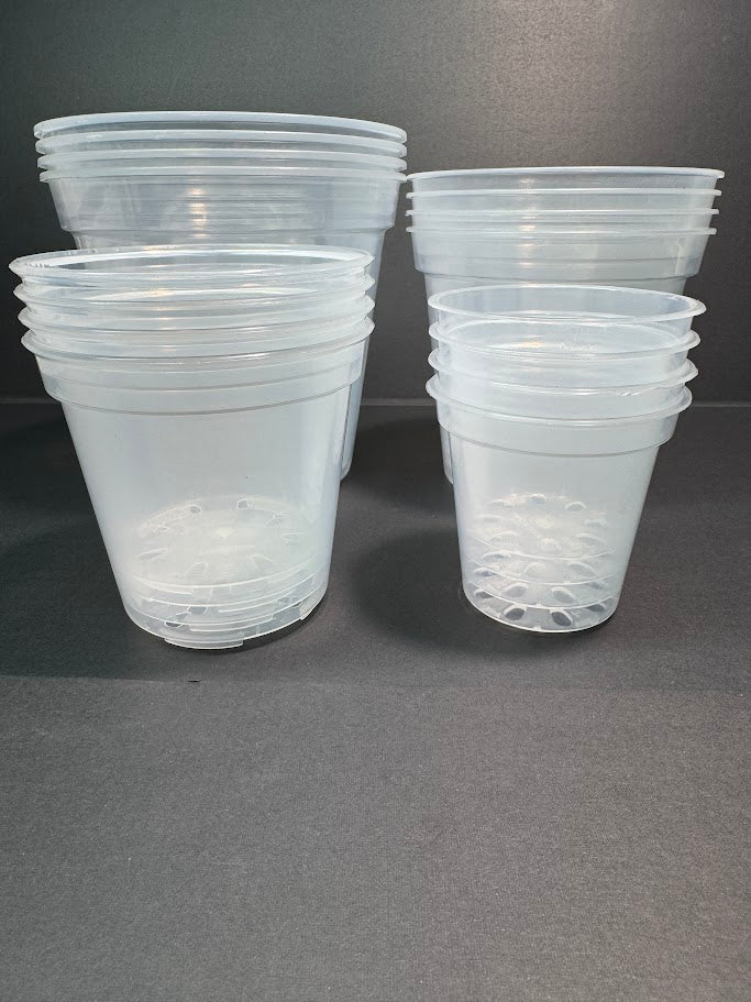 Stacks of clear plastic plant pots on a gray background