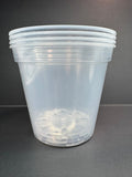 Stack of four clear plastic nursery pots on a gray background