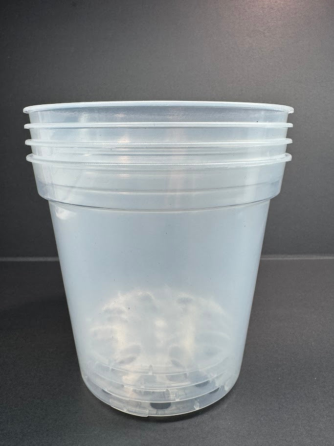 Stack of clear plastic nursery pots on a gray background