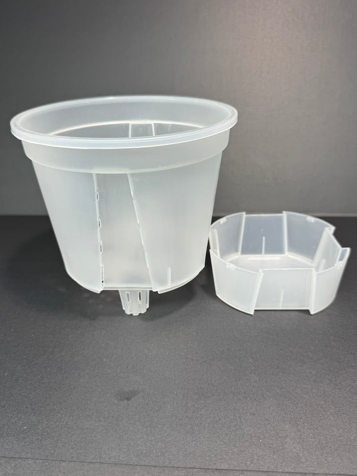 A inch self watering pot, detached from and showing the reservoir base separately.