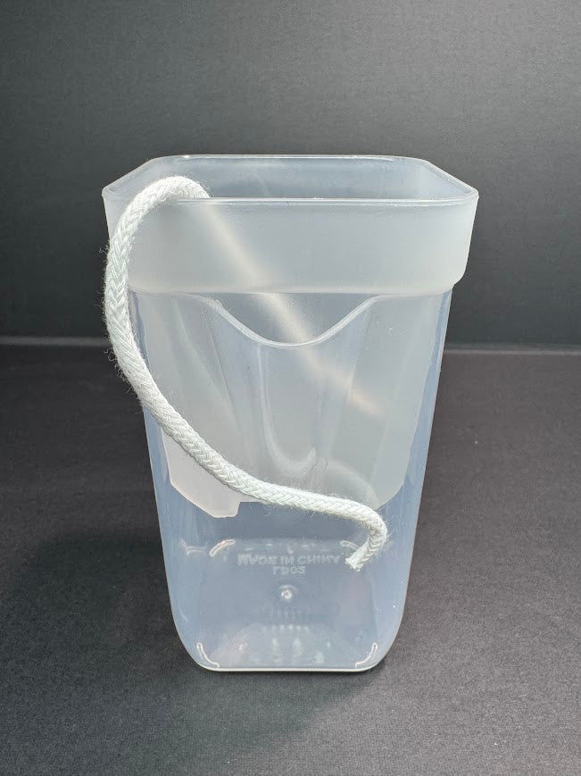 A translucent clear plastic cup with a white braided carrying loop, shown on a dark gray background.
