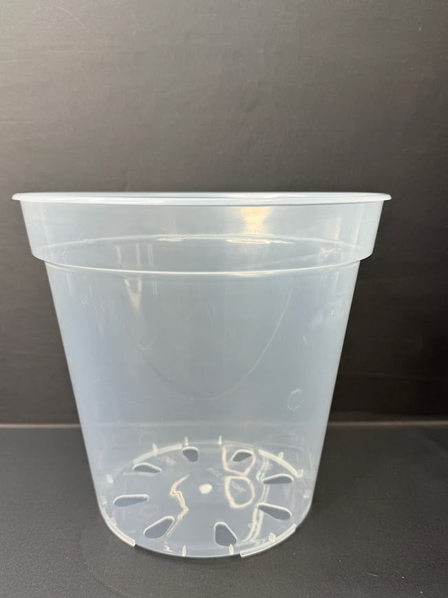 A clear plastic nursery pot with a drainage hole design at the bottom, shown against a dark gray background.