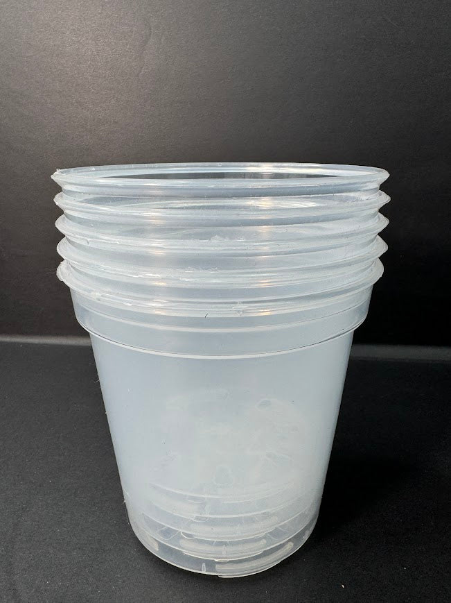 A stack of translucent clear plastic cups with ridged rims, photographed against a dark gray background.