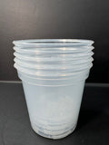 A stack of translucent clear plastic cups with ridged rims, photographed against a dark gray background.