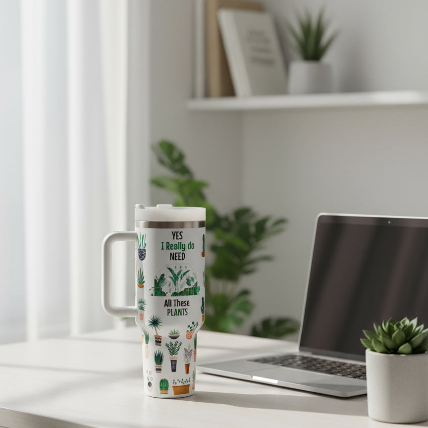 Travel mug with plant design on a desk with laptop and plants
